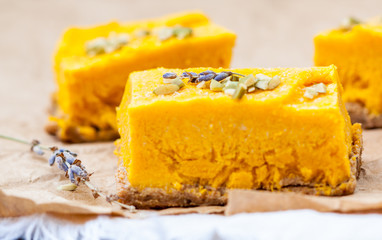 Slices of raw vegan pumpkin cheesecake. Love for a healthy raw desserts concept.