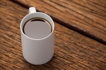 Cup of coffee on wooden table