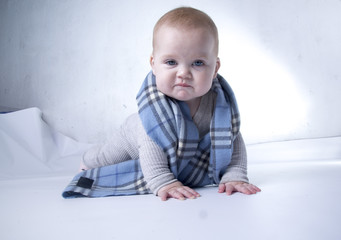 the kid on the background with blue eyes in a scarf