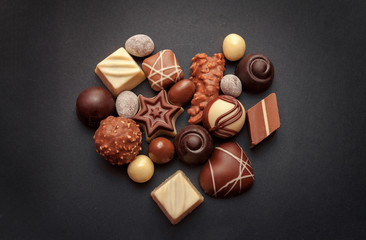 Chocolate pralines on dark background