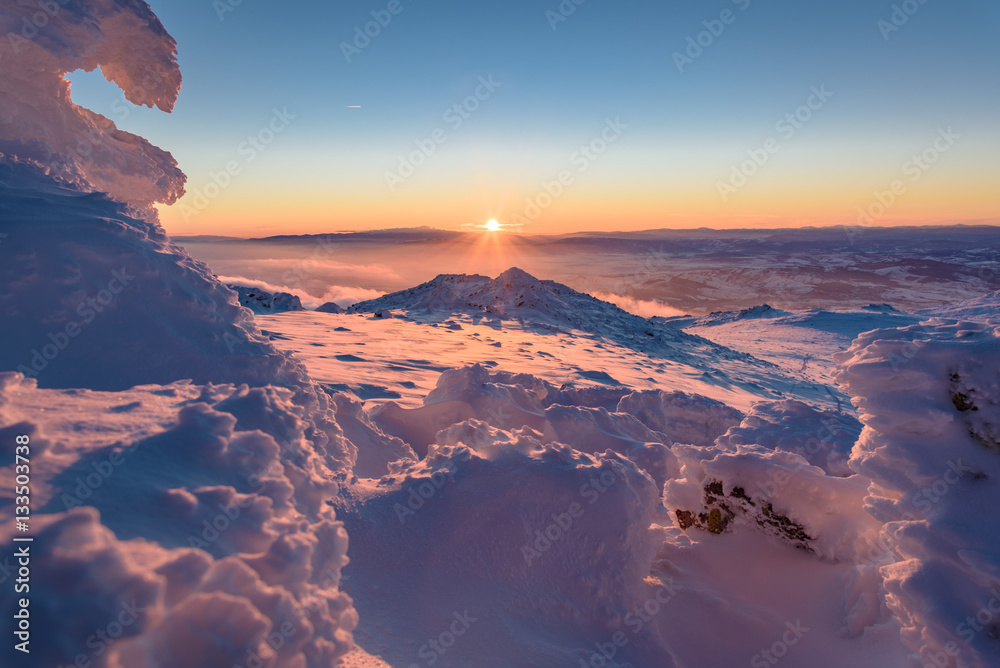 Wall mural Frozen pink figures - beautiful winter landscape on a mountain top at sunset