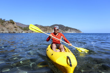 Travel by sea kayak on a sunny day.