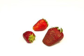 Red strawberries on a table on a white background