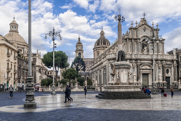 Fototapeta na wymiar Piazza Duomo square in the hstoric center of Catania, Sicily, Italy, with a beautiful sky in the background