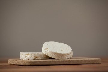 Slices of cheese on chopping board