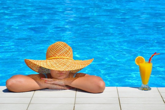 Real female beauty relaxing at swimming pool