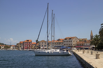 Fototapeta na wymiar Houses near the sea in port of Stari Grad on adriatic island Hvar in Croatia, Europe