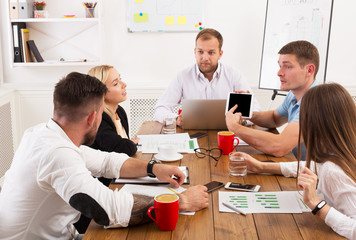 Business meeting. Young hipsters businessmen and women at modern office