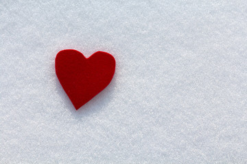 Obraz premium Cutout red heart in the snow