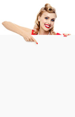 woman in pin-up style dress, showing blank signboard