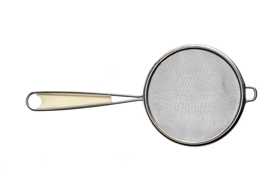 Small metallic tea strainer sieve with handle isolated on white.