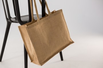 Jute bag hanging on a black chair
