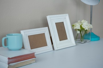 Picture frames, coffee cup with and flower vase