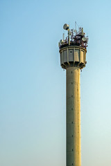 Tower with different antennas under clear sky