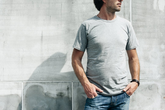 Handsome guy in gray t-shirt over street wall