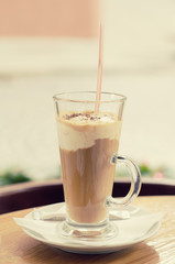 Coffee with cream in a cafe, vintage food background for menu in a cafe