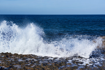 Sea wave splashing on rocks, natural holiday vintage hipster seasonal background