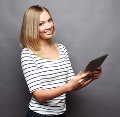 Beautiful modern woman using digital tablet