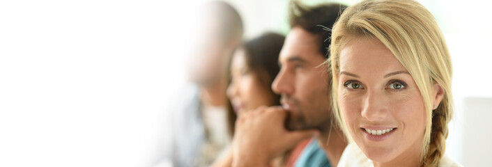 Beautiful blond woman attending business meeting