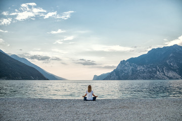 Woman meditating at the lake
