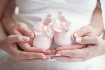 Happy pregnancy girl with shoes, selective focus.