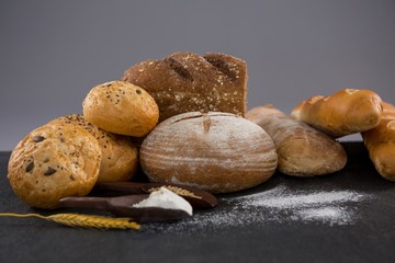 Bread loaves with wheat grains and flour
