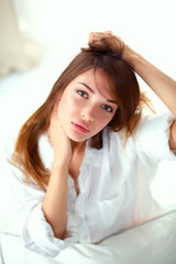 Fototapeta premium Portrait of beautiful woman on bed at bedroom