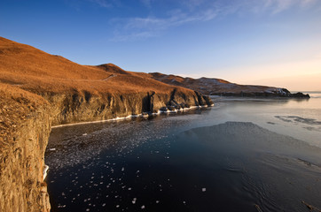 The rocky coast of the cold winter morning.