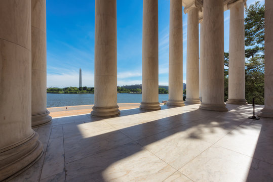Columns at the Jefferson Memorial and the Washington monument on the horizon in Washington DC.