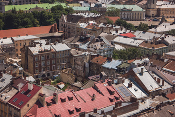 Fototapeta na wymiar Buildings in a town. Rooftops under sunlight. Townscape during summer.