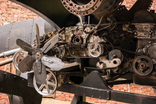 Parts of old engine. Steel wheels and fan. Start the heart of machine.