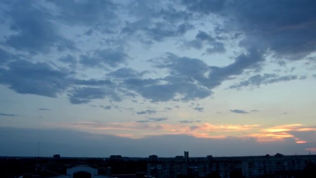 Time-lapse photography include the movement and change the state of clouds in the evening sky  over the city when the sunset.
