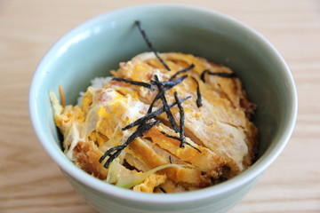 Japanese deep fried pork with egg on rice , Katsudon on wood bac