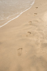 Fototapeta na wymiar Footprints in sand