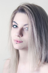 Fototapeta premium Beautiful caucasian young girl with lip piercing, studio shot
