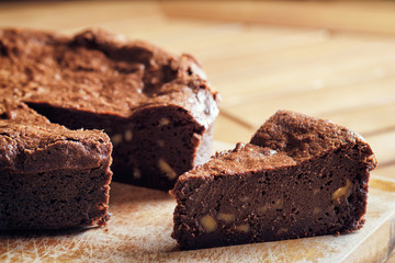 Piece of freshly baked chocolate brownie cake with walnuts