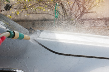 Car wash with flowing water and foam.