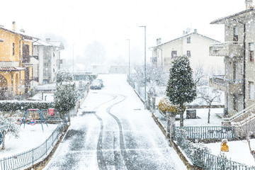 Snow falling in town in winter