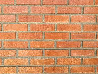 horizontal orange bricks wall hold by cement