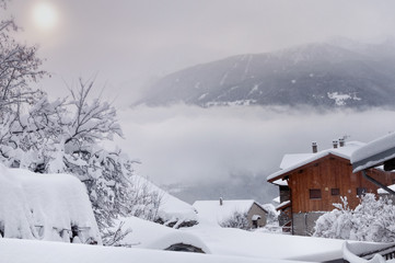 Naklejka premium paysage sous la neige et dans les nuages en montagne 