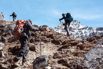 Mountain Climbers Team walking up on rocky Footpath