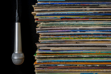 A stack of old records and hanging microphone
