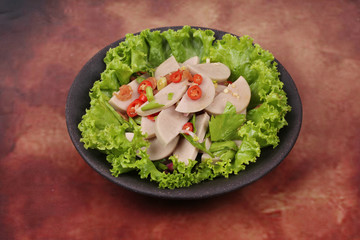 Spicy mixed vegetable salad with sliced Thai white pork sausage