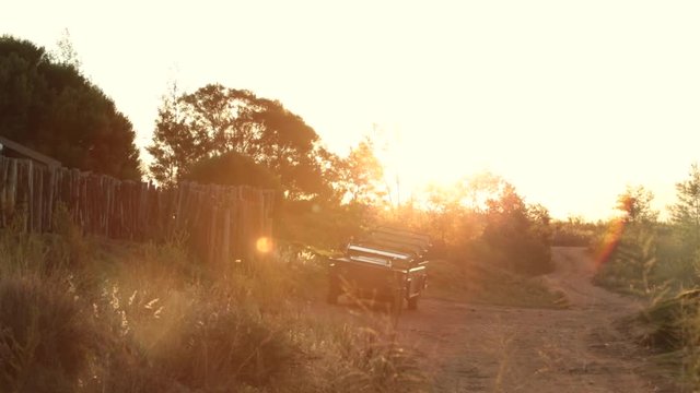 Slow pan over safari camp at sunset
