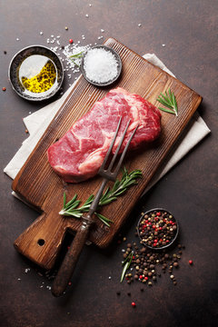 Raw ribeye beef steak cooking with ingredients