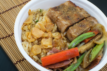 fried garlic rice with pork on black background