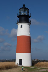 Fototapeta na wymiar Sankaty Head Light lighthouse on Nantucket Island - little boy i