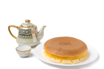 Fish cake with teapot and tea glass on white background