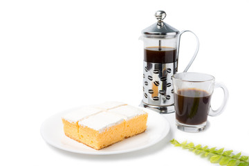 Coconut cream cake with coffee glass on white background