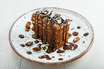 Chocolate Spartak cake for delicious dessert on a table. Traditional sweet food on a rustic plate.